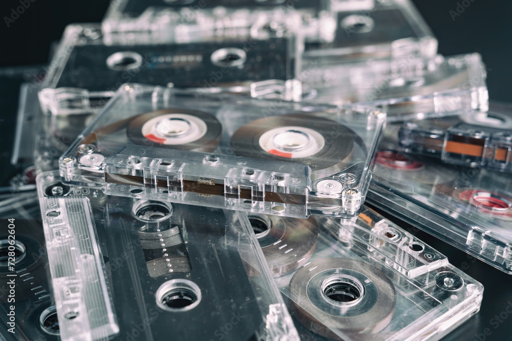 Fototapeta premium A stack of audio tape cassettes on black background. Retro vintage music concept.