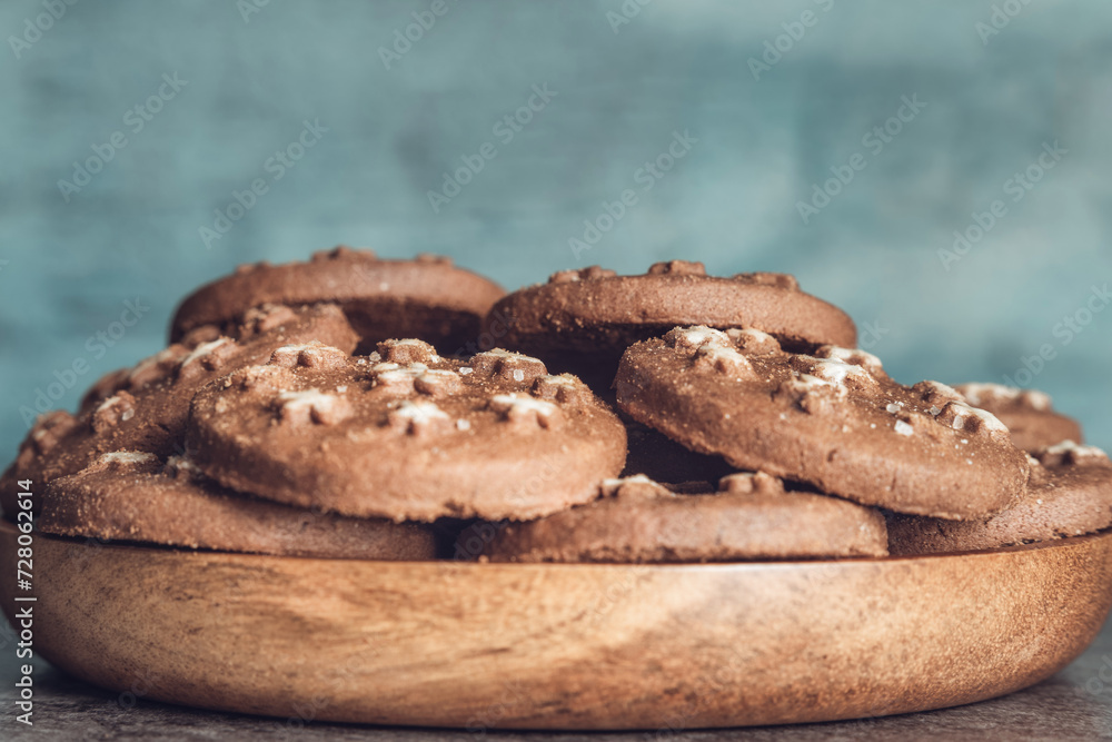 Delicious sweet cocoa cookies biscuits on a wooden plate Delicious sweet cocoa cookies biscuits on a wooden plate