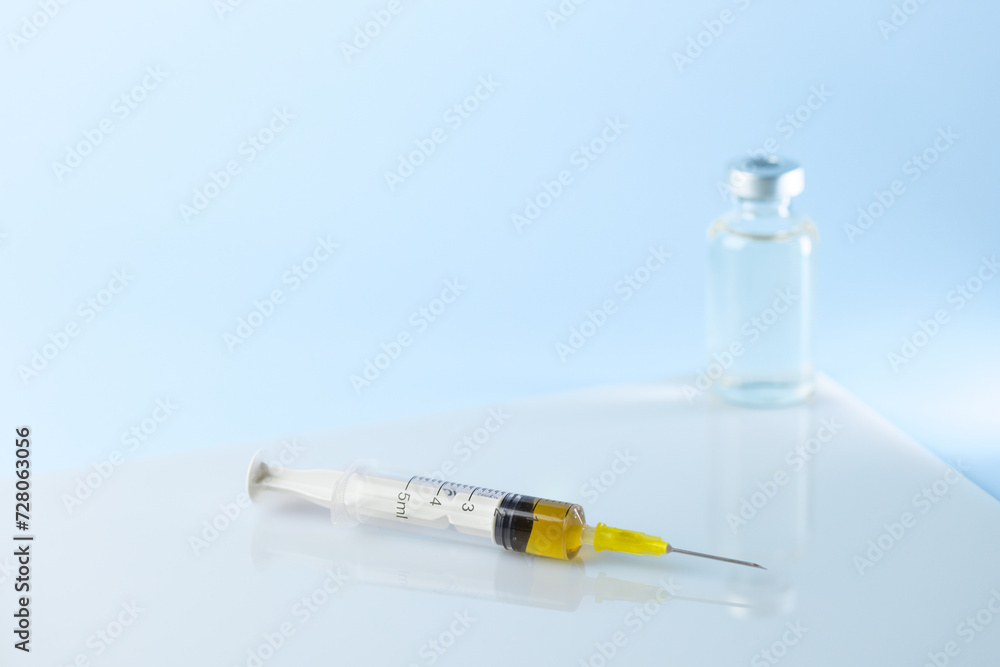 syringe for injectable medication on blue background syringe for injectable medication on blue background