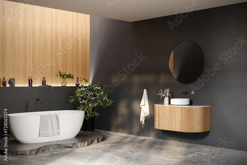 Comfortable bathtub and vanity with basin standing in modern bathroom black and wooden walls and concrete floor.Side view.