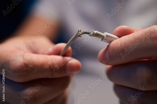 Obraz na plátně Old charger cable broken and smartphone, Defective charging cord, Connection det