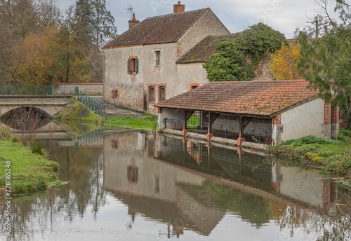 old fashioned french wash house by the side of a lake