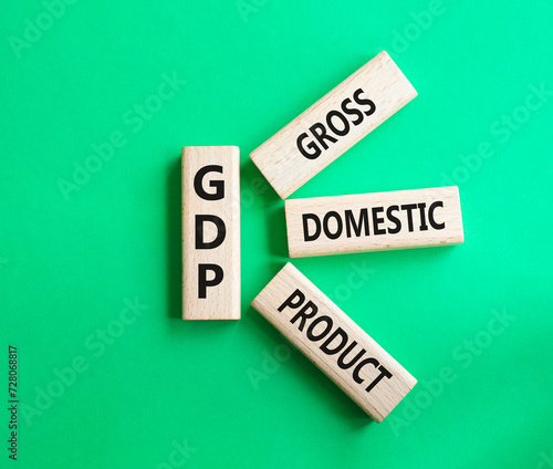GDP - Gross domestic product symbol. Concept word GDP on wooden blocks. Beautiful green background. Business and GDP concept. Copy space.