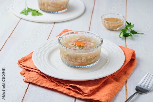 Cuadro en lienzo Cold appetizer, jellied meat from turkey and pork in portioned molds on a light wooden background