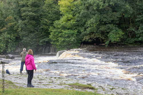 woman stood next to river 