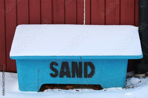 Box for sand. Sand icy road.  Blue, plastic box out. Winter roads are sanded.
