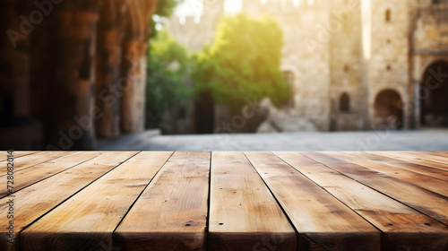 Wooden table foreground with a soft-focus medieval castle background. Table mockup for product presentation