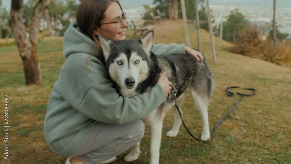 Happy young casual woman hugging cute Husky dog enjoy love and friendship at autumn city park Happy young casual woman hugging cute Husky dog enjoy love and friendship at autumn city park