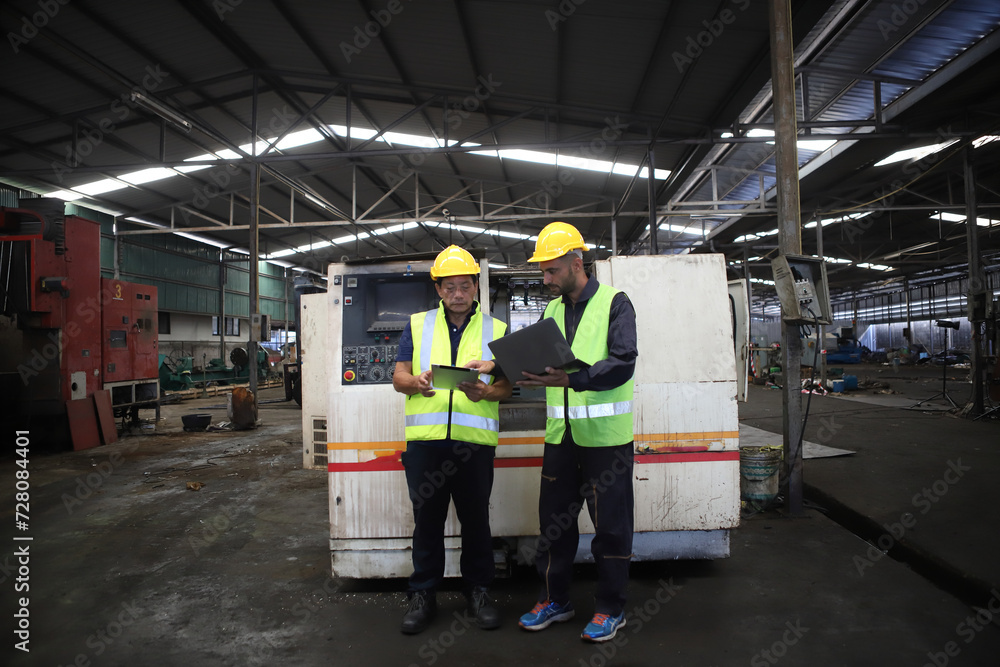worker or engineer working in factory with safety uniform , safety hat and safety glasses , image is safety concept or happy workplace worker or engineer working in factory with safety uniform , safety hat and safety glasses , image is safety concept or happy workplace