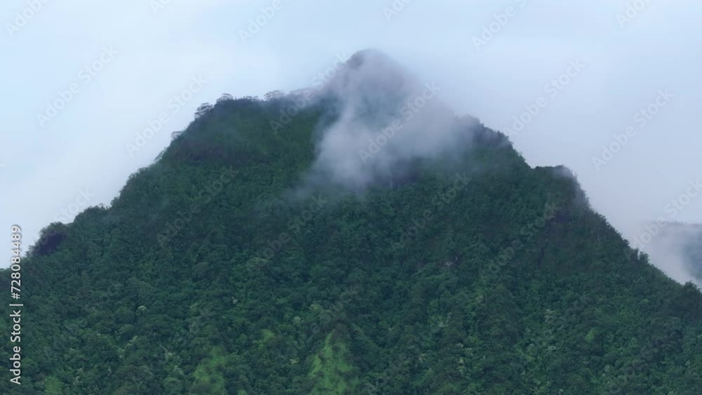 Dramatic views over green jungle peak. Kualoa ranch on overcast cloudy day Hawaii. Scenic beauty tropical nature landscape. Drone flying above rainy mountain ridge. Outdoor adventure on Oahu island Dramatic views over green jungle peak. Kualoa ranch on overcast cloudy day Hawaii. Scenic beauty tropical nature landscape. Drone flying above rainy mountain ridge. Outdoor adventure on Oahu island