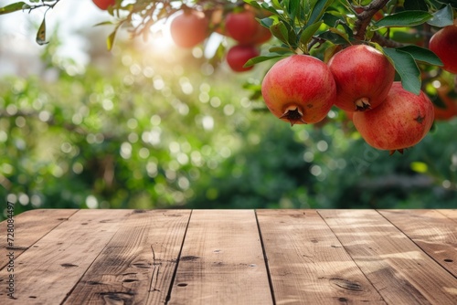 an empty wooden boardwalk on a blurred background of a garden with pomegranates. display your product outdoors. mockup.