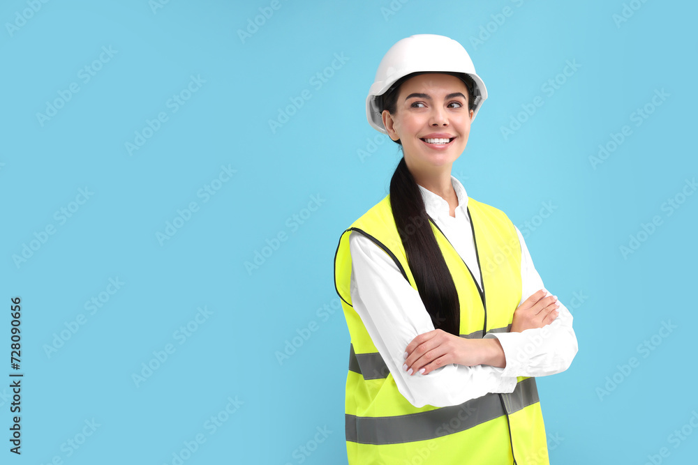 Engineer in hard hat on light blue background, space for text Engineer in hard hat on light blue background, space for text