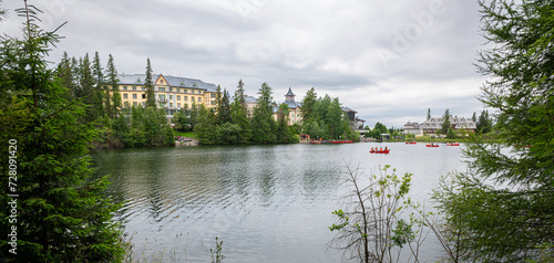 Scenic view of buildings along a lake in tourist resort Štrbské Pleso in Tatra Mountains of Slovakia