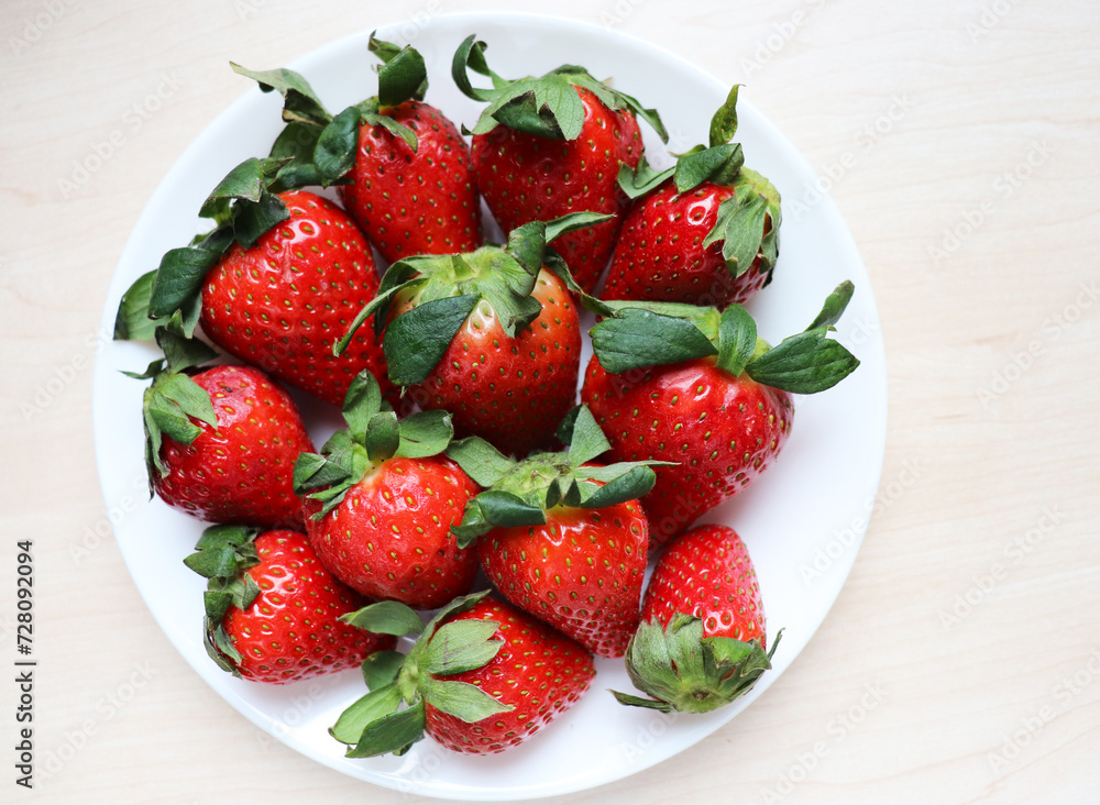 fresh ripe strawberries and a bouquet of pink roses fresh ripe strawberries and a bouquet of pink roses
