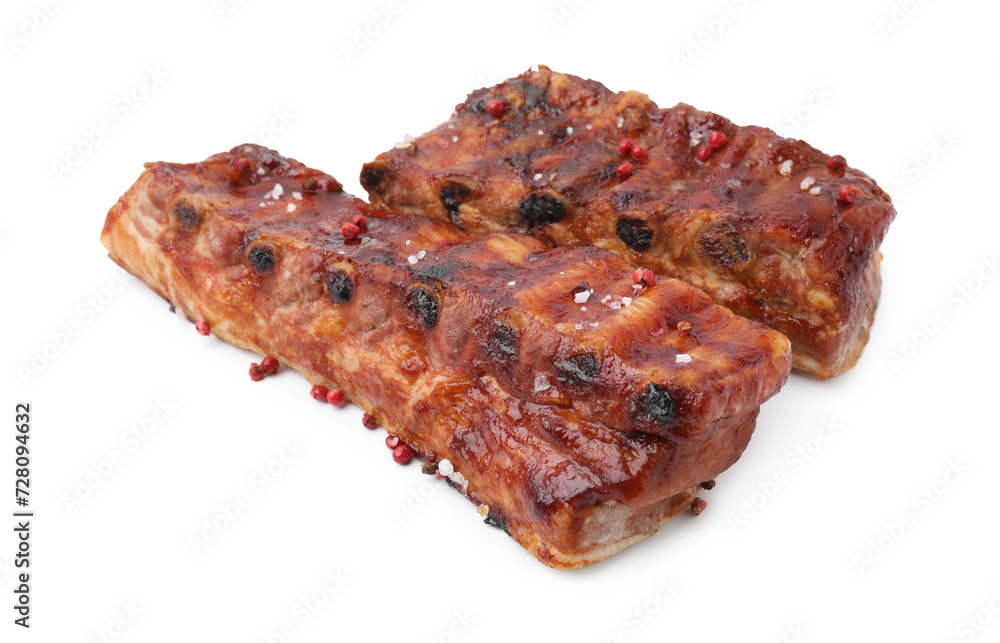 Tasty roasted pork ribs and peppercorns isolated on white