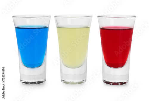 Different shooters in shot glasses isolated on white. Alcohol drink