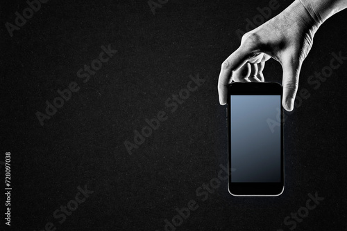 Hand Holding Mobile Phone in Black and White on Textured Paper Background, Copy Space