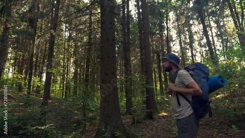 Wallpaper Mural Tourist with backpack Hiking on Adventure Trip in Natural Landscape Woodland. Solo Adventure Inspiring travel with Hiking equipment. slow motion side view Torontodigital.ca