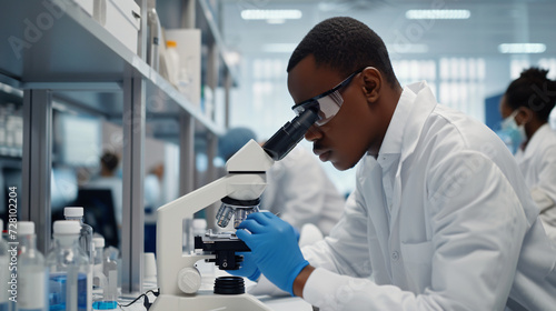 African scientist checking sample of virus using.
