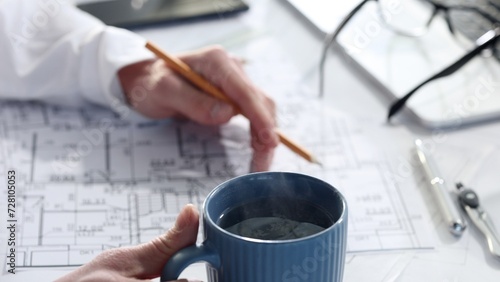 Drawing drawings and house layout with a cup of coffee