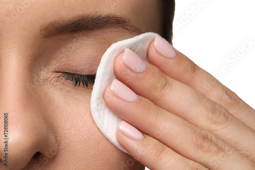 Photos Woman removing makeup with cotton pad on white background, closeup
