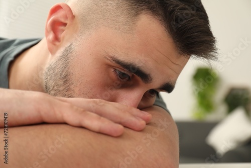 Portrait of sad man on blurred background, closeup
