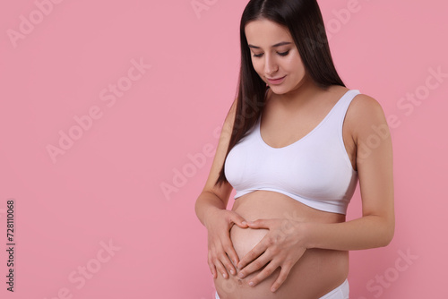 Wallpaper Mural Beautiful pregnant woman in stylish comfortable underwear making heart with hands on her belly against pink background, space for text Torontodigital.ca