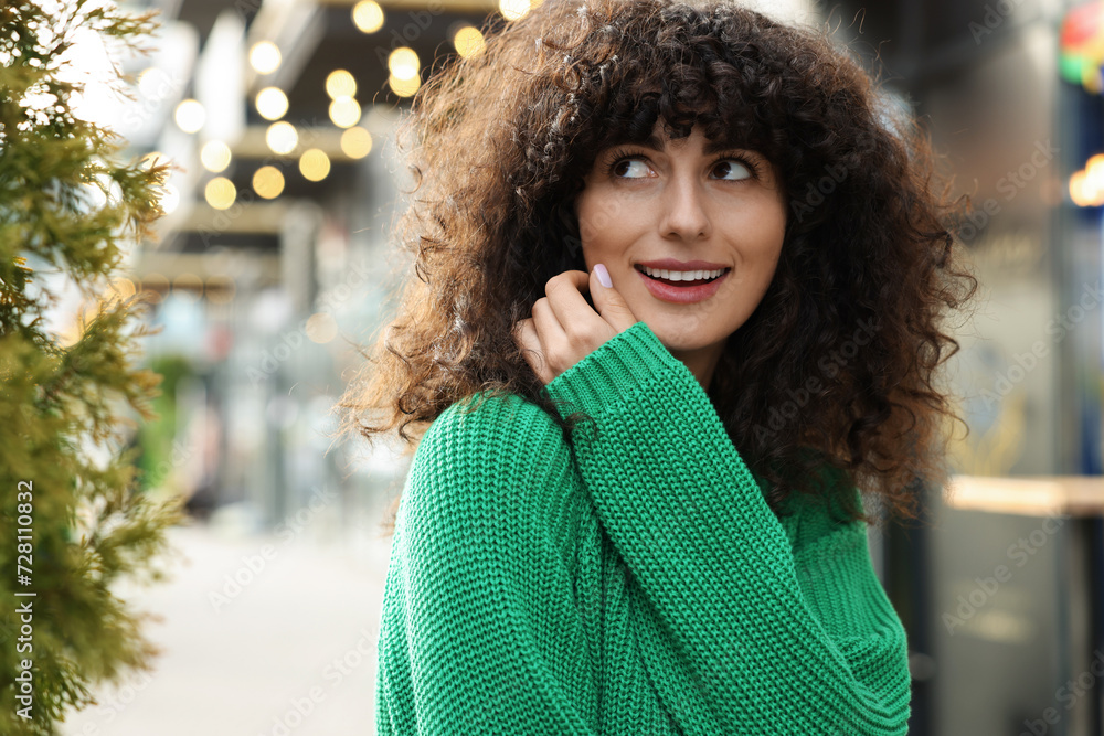 Happy young woman in stylish green sweater outdoors Happy young woman in stylish green sweater outdoors