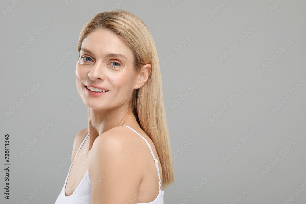Fototapeta premium Beautiful woman with healthy skin on gray background, space for text