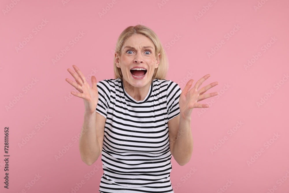 Portrait of surprised woman on pink background Portrait of surprised woman on pink background
