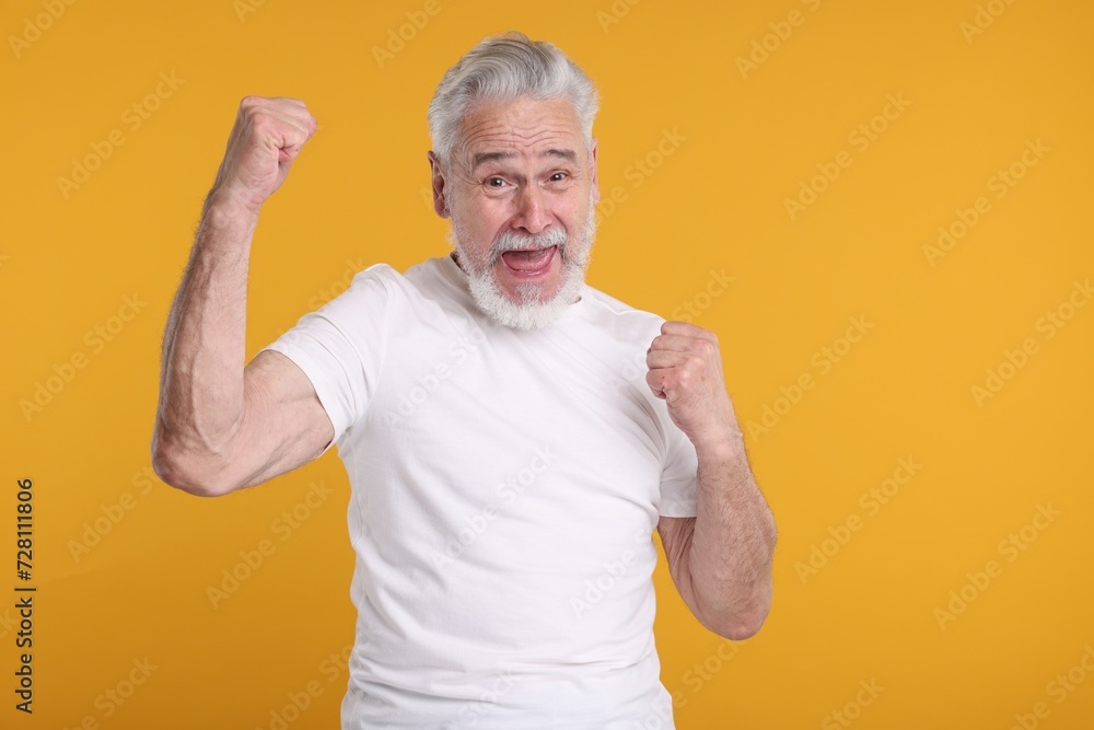 Portrait of surprised senior man on yellow background Portrait of surprised senior man on yellow background