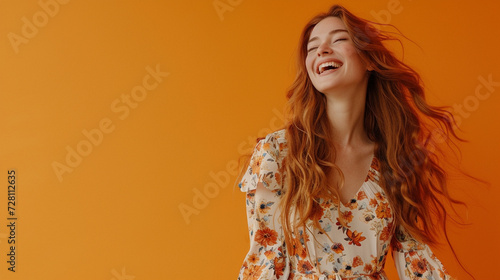 A full body depiction of a happy young woman white teeth with long auburn hair, wearing a floral maxi dress, standing alone against an orange background, created to look like a shot from an HD camera
