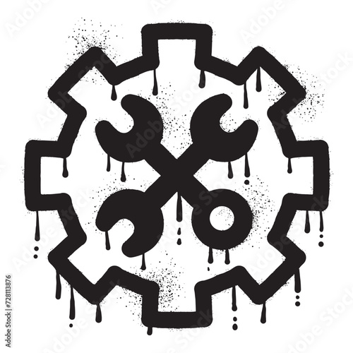 Wrench graffiti on gear wheel drawn with black spray paint