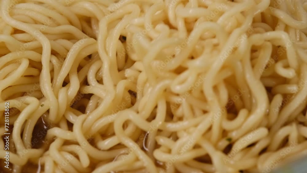 golden tortilla in a wooden plate and Chinese chopsticks. Asian noodles close up golden tortilla in a wooden plate and Chinese chopsticks. Asian noodles close up