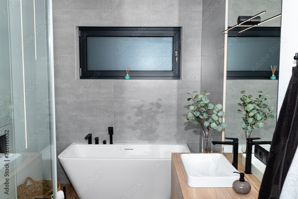 LED light strips mounted in the wall in a modern bathroom, visible bathtub. LED light strips mounted in the wall in a modern bathroom, visible bathtub.