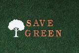 Wooden alphabet arranged in ecological awareness campaign with ECO icon design on biophilia green grass background to promote environmental protection for greener and sustainable future. Gyre