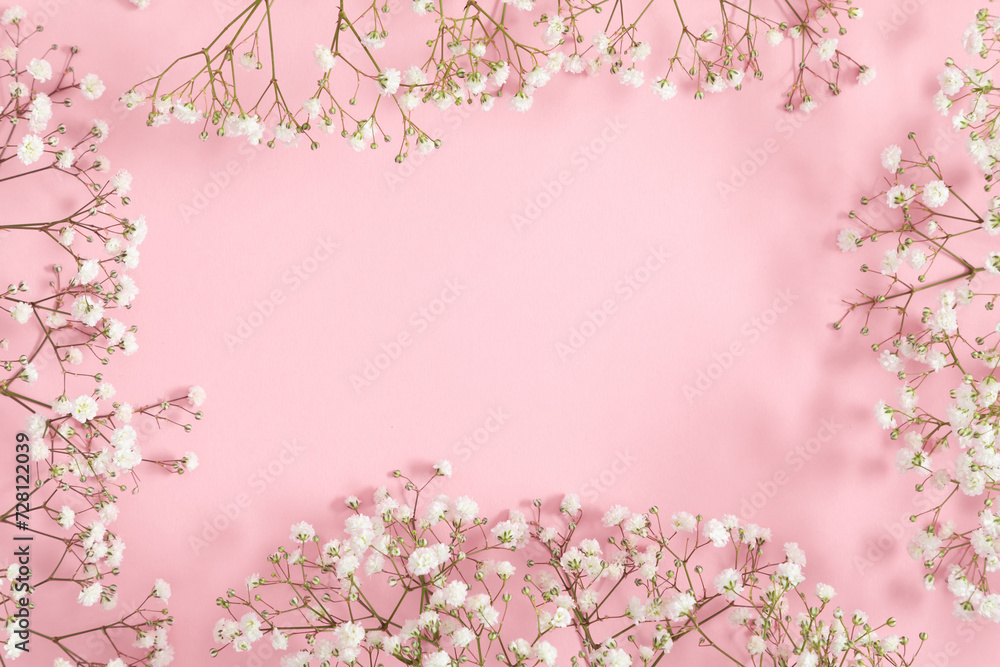Small white gypsophila flowers on pastel pink background. Happy Women's Day, Wedding, Mother's Day, Easter, Valentine's Day. Flat lay, top view, copy space