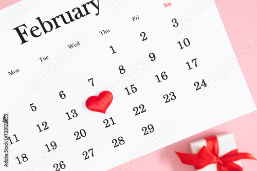 Valentine's Day background. Date February 14 on calendar 2024. Gift box and valentine hearts. Valentines day concept. Flat lay, top view, copy space