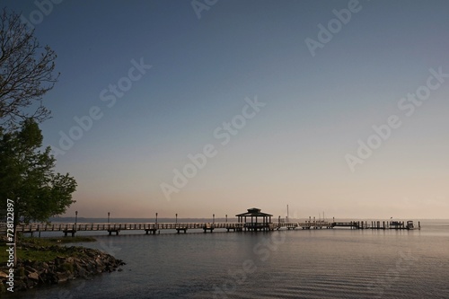 Pier reaching far into the St. Johns River on a clear, bright morning in Florida