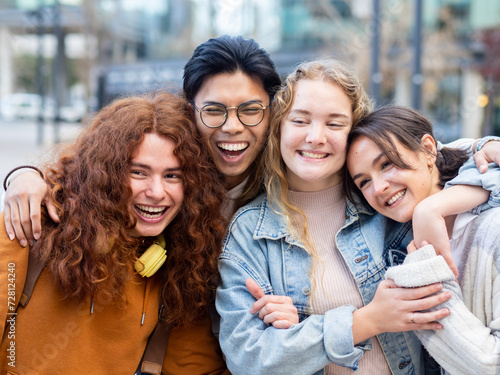 Group of young teenagers having fun hugging in a city. Concept of camaraderie and unity