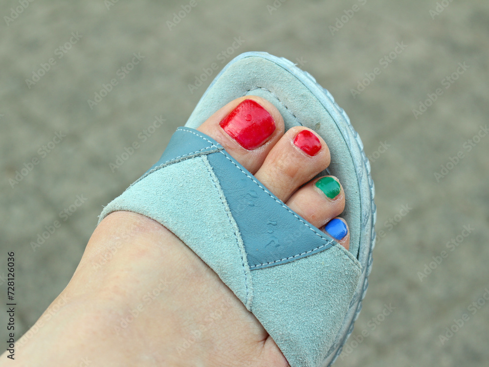 Fototapeta premium feet in shoes, colorful toenails
