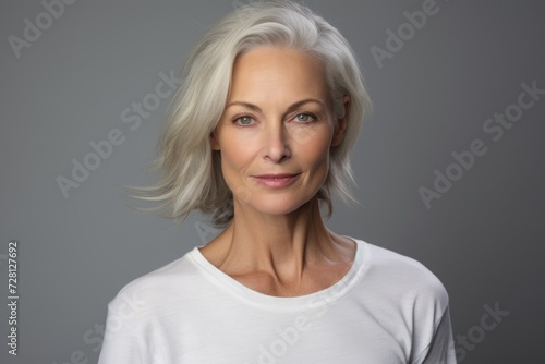 Portrait of a beautiful middle-aged woman with short gray hair. © Asier