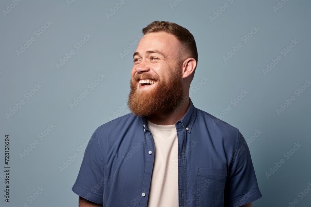 Portrait of a happy young man with a beard on a blue background Portrait of a happy young man with a beard on a blue background
