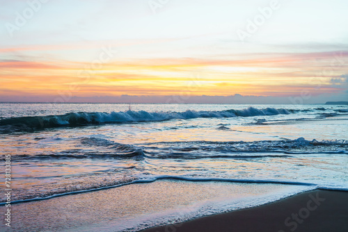 The sun gracefully dips below the horizon  casting warm hues across the tranquil sands during a sunset