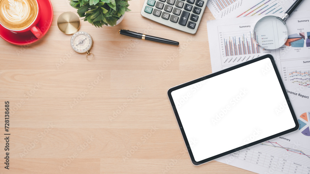 An orderly workspace featuring a blank tablet screen, cup of coffee, and printed financial documents ready for review. An orderly workspace featuring a blank tablet screen, cup of coffee, and printed financial documents ready for review.