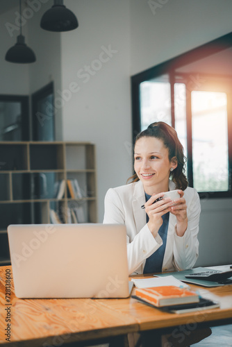 BUsiness woman concept, A content businesswoman enjoys a coffee break in a well-lit office, with her laptop and work materials nearby.