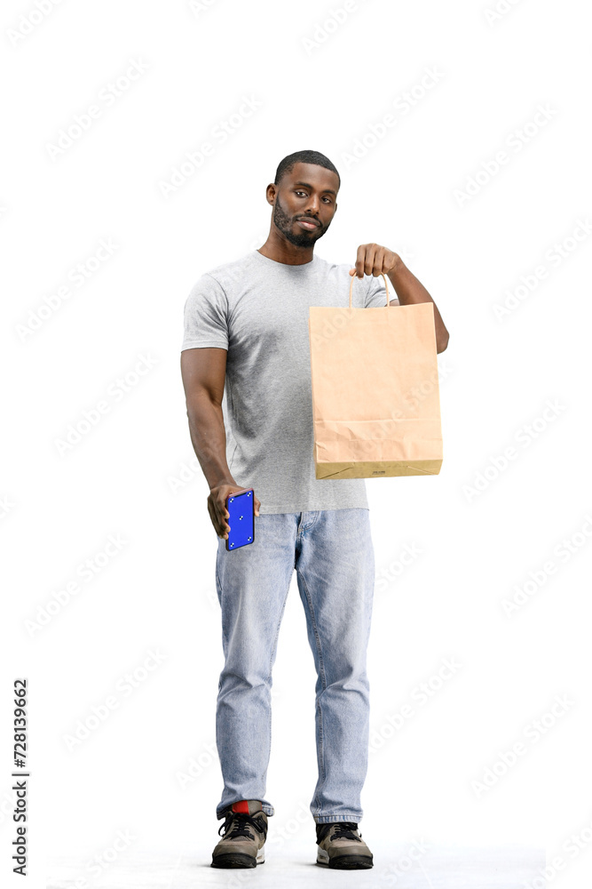 A man, full-length, on a white background, with bags and a phone A man, full-length, on a white background, with bags and a phone