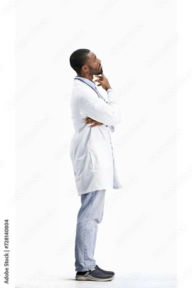 The doctor, in full height, on a white background, thinks The doctor, in full height, on a white background, thinks