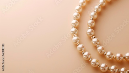 Elegant pearl necklace laid out on a soft beige surface