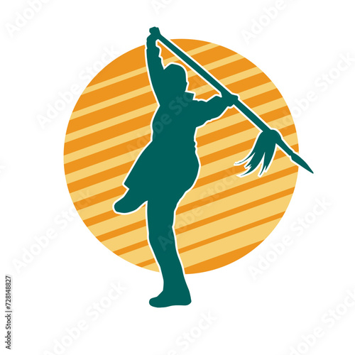Silhouette of a wushu martial artist in action pose with a spear weapon. Silhouette of a fighter carrying a spear weapon.